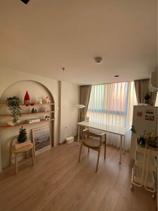 Decorative bedroom with desk, shelves, and window