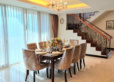 Elegant dining area with a chandelier and decorated dining table