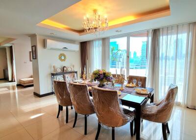 Elegant dining room with chandelier and table setup near a large window