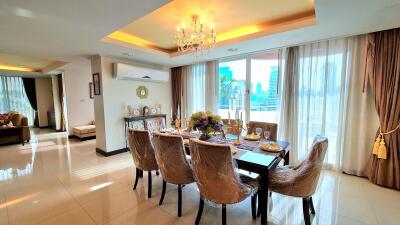 Elegant dining room with chandelier and table setup near a large window