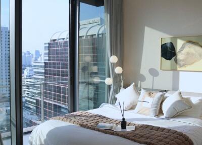 Bedroom with large windows and city view