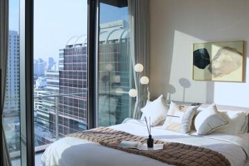 Bedroom with large windows and city view