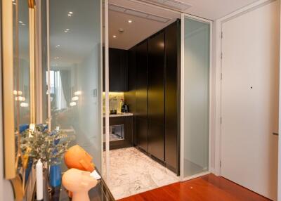 Contemporary kitchen with black cabinetry and marble flooring