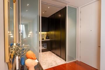 Contemporary kitchen with black cabinetry and marble flooring