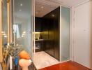 Contemporary kitchen with black cabinetry and marble flooring