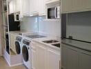 Modern kitchen with built-in appliances and washer-dryer