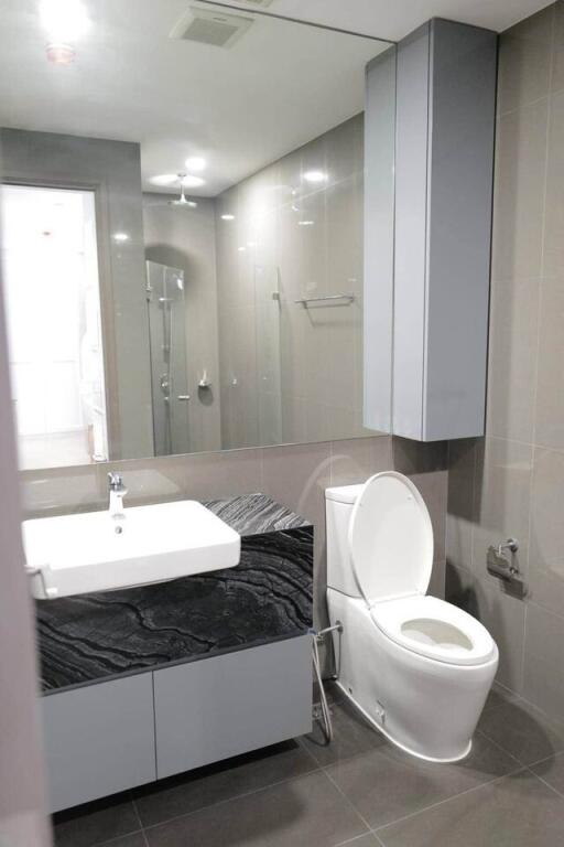 Modern bathroom with large mirror and sleek fixtures