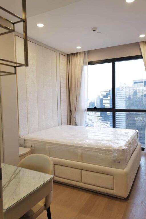 bedroom with large window and city view