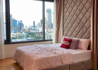 Modern bedroom with large window and city view