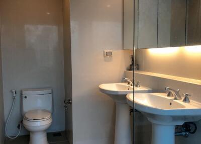 Modern bathroom with double sinks and toilet