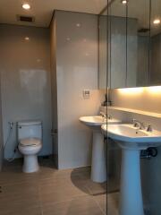 Modern bathroom with double sinks and toilet