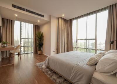 Spacious bedroom with large windows and natural light