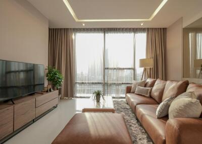 Modern living room with leather sofa and large windows