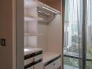 Modern walk-in closet with built-in shelving and drawers