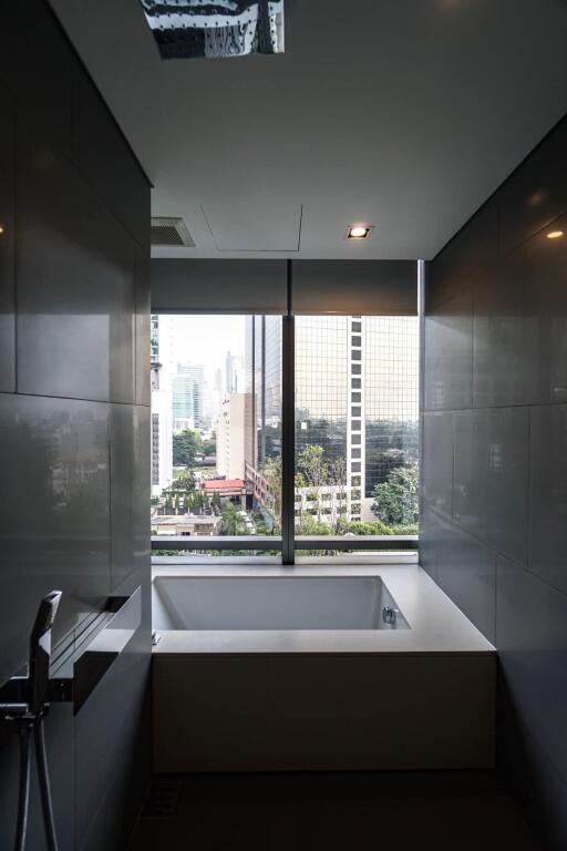 Modern bathroom with tub and city view