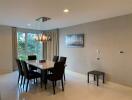 Modern dining room with a stylish table, six chairs, and a contemporary light fixture