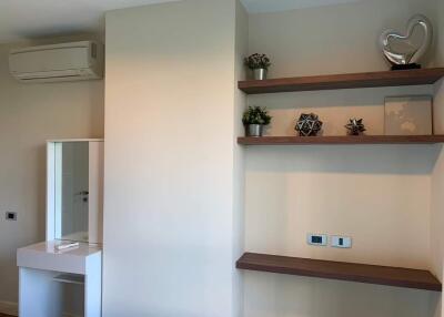 Modern bedroom with organized shelves and air conditioning