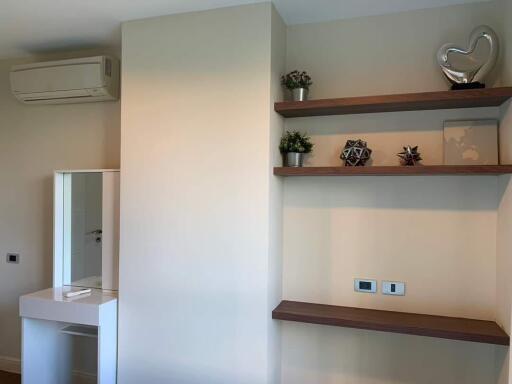 Modern bedroom with organized shelves and air conditioning