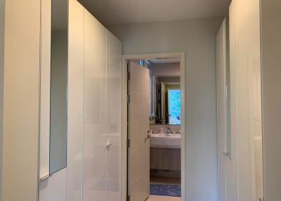 View of a bathroom with white cabinets and a sink