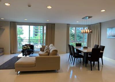 Spacious living and dining area with modern furniture and bright lighting