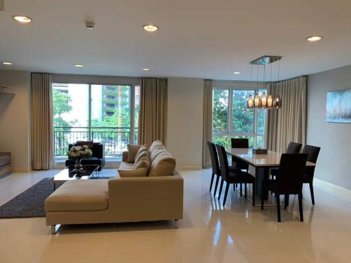 Spacious living and dining area with modern furniture and bright lighting