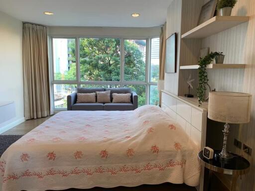 Bedroom with large window and cozy decor