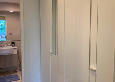 Hallway with wardrobe and view into bathroom