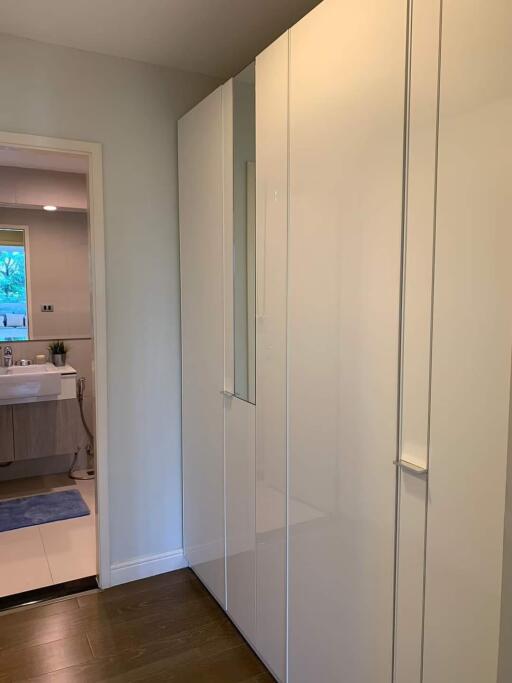 Hallway with wardrobe and view into bathroom