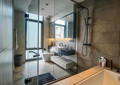 Modern bathroom with glass partition and fixtures