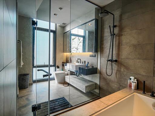 Modern bathroom with glass partition and fixtures