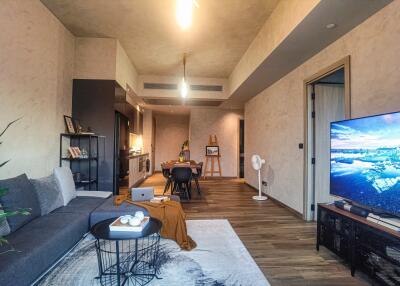 Modern open-concept living room with a view into the kitchen and dining area