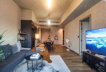 Modern open-concept living room with a view into the kitchen and dining area