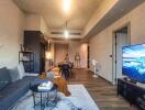 Modern open-concept living room with a view into the kitchen and dining area