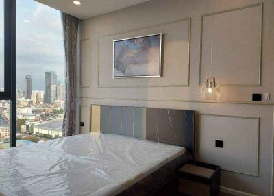 Modern bedroom with a large window and city view