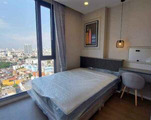 Modern bedroom with large window and city view