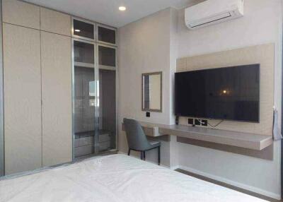 Modern bedroom with TV and study area