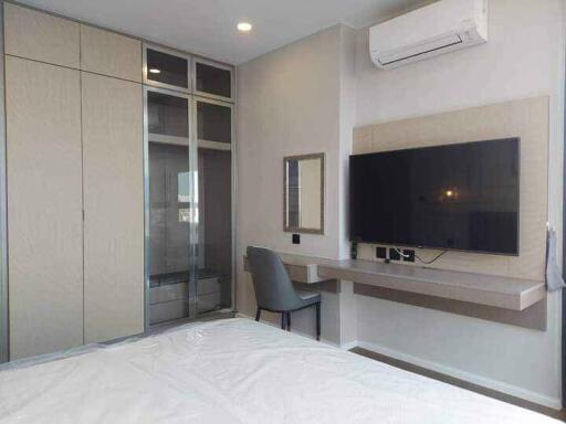 Modern bedroom with TV and study area