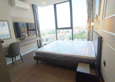 Modern bedroom with large windows and city view