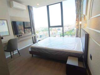 Modern bedroom with large windows and city view