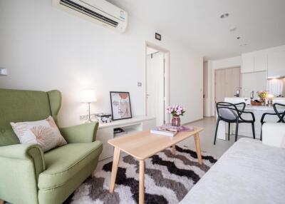 Modern living room with green armchair and wooden coffee table