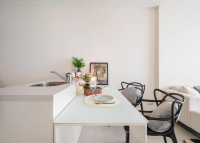 Modern kitchen with dining area and living room in background