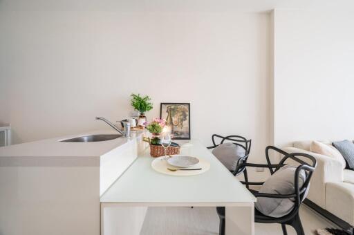 Modern kitchen with dining area and living room in background