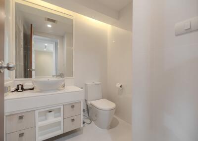 Modern bathroom with vanity, sink, and toilet