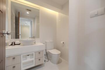 Modern bathroom with vanity, sink, and toilet