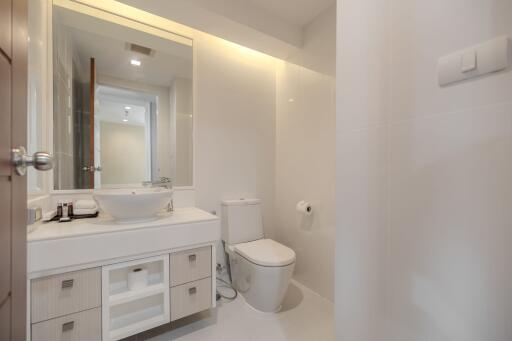 Modern bathroom with vanity, sink, and toilet