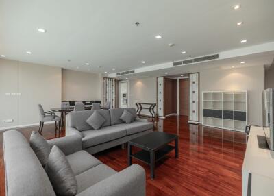 Spacious and modern living room with hardwood floors and contemporary furniture