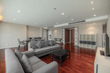 Spacious and modern living room with hardwood floors and contemporary furniture