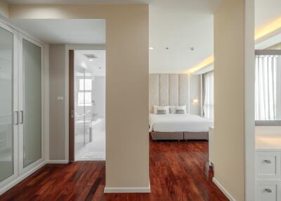 Modern bedroom with en suite bathroom and wooden flooring