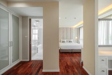 Modern bedroom with en suite bathroom and wooden flooring