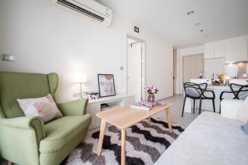 Cozy living room with green armchair, wooden coffee table, and modern decor